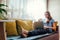 Young woman using her laptop in the livingroom