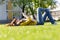 Young woman using her smart phone while laying on grass in park on her lunch break