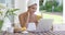 Young woman using a laptop while having breakfast