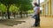 Young woman using mobile phone while leaning on pole with skateboard 4k