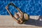 young woman using mobile phone at the swimming pool. Summertime, technology and lifestyle outdoors. Taking a selfie with smart