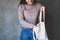 A young woman using and picking stuff out off a white fabric tote bag for reusable and environment concept