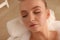 Young woman using pillow while enjoying bubble bath indoors, closeup