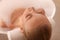 Young woman using pillow while enjoying bubble bath indoors, closeup