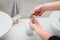 young woman using soap dispenser and washing hands at home