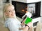 Young woman using tablet computer in front of fireplace