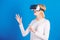 Young woman using a virtual reality headset with conceptual network lines. Woman using VR device. Cheerful smiling woman