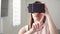 Young woman using VR virtual reality 360 glasses at home. Making browse, zoom and tap gestures