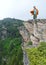 Young woman on a vertical mountain rock