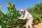 Young woman, vine grower, in the vineyard.