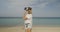 Young woman with virtual reality glasses on the beach