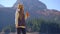 A young woman visits the Crno jezero or the Black lake near the city of Zabljak. She drinks hot drink from a thermos