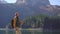 A young woman visits the Crno jezero or the Black lake near the city of Zabljak. He drinks hot drink from a thermos