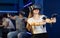 Young woman in VR glasses playing virtual game with handheld controllers