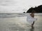 Young Woman Wading In Ocean