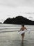 Young Woman Wading In Ocean