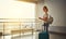 young woman waiting for flying at airport at window with suitcase .