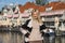 Young woman waiting for tour boat in Amsterdam, the Netherlands