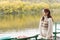 Young woman waiting at a tranquil river