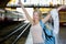 Young woman waiting in vintage train, relaxed and carefree at the station platform in Bangkok, Thailand before catching a train.