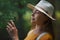 Young woman on a walk outdoors in forest in summer nature, daydreaming.