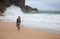 Young woman walking alone on the deserted coast of the Atlantic