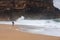 Young woman walking alone on the deserted coast of the Atlantic