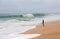 Young woman walking alone on the deserted coast of the Atlantic