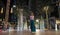A young woman is walking along the evening Dubai.