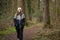 Young woman walking along a trail in a serene forest