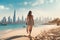 Young woman walking on the beach with Dubai city skyline in the background, A beautiful woman walking on the beach in Dubai. In