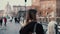 Young woman walking in city centre, Roman Forum. Female traveler takes photo of old town ruins. Girl exploring Italy.