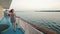 Young woman walking on deck of cruise ship