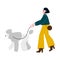 Young woman walking a dog breed poodle.