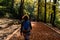 Young woman walking in forest. Adventure style. Autumn colours. Beautiful nature and young girl.