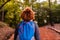 Young woman walking in forest. Adventure style. Autumn colours. Beautiful nature and young girl.