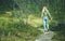 Young Woman walking in forest wooden road alone