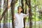 Young woman walking and happiness traveling in the forest at the capital city.