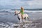 young woman walking with horse at the beach, horseback