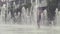 Young woman walking inside the fountain