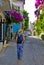 Young woman walking in narrow street in Alacati, Cesme