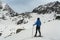 Young woman walking with snow rackets in high mountain