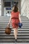 Young woman walking stairs at a train station