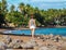 Young woman walking on tropical beach. Summer vacation casual photo