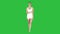 Young woman walking in white sports clothes barefoot and smiling widely on a Green Screen, Chroma Key.