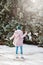 Young woman walking on winter day, holding travel stainless Steel mug with hot coffee. reusable water bottle