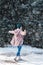 Young woman walking on winter day, holding travel stainless Steel mug with hot coffee. reusable water bottle