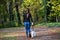 Young woman walks the dog in the woods