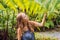 A young woman walks among the ferns