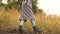 A young woman walks on a hill. Girl wearing a coat